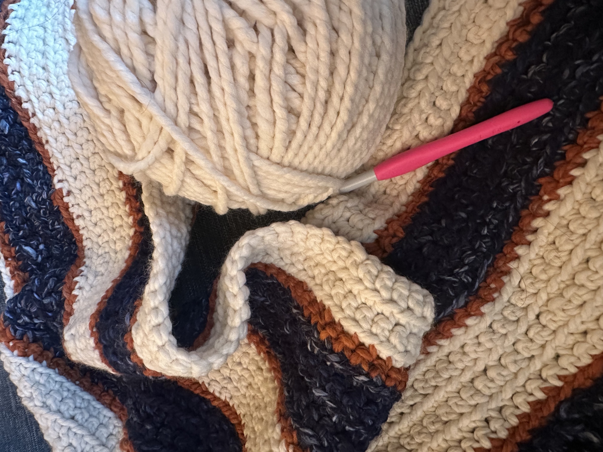 Crocheting a blanket in UVA's blue and orange